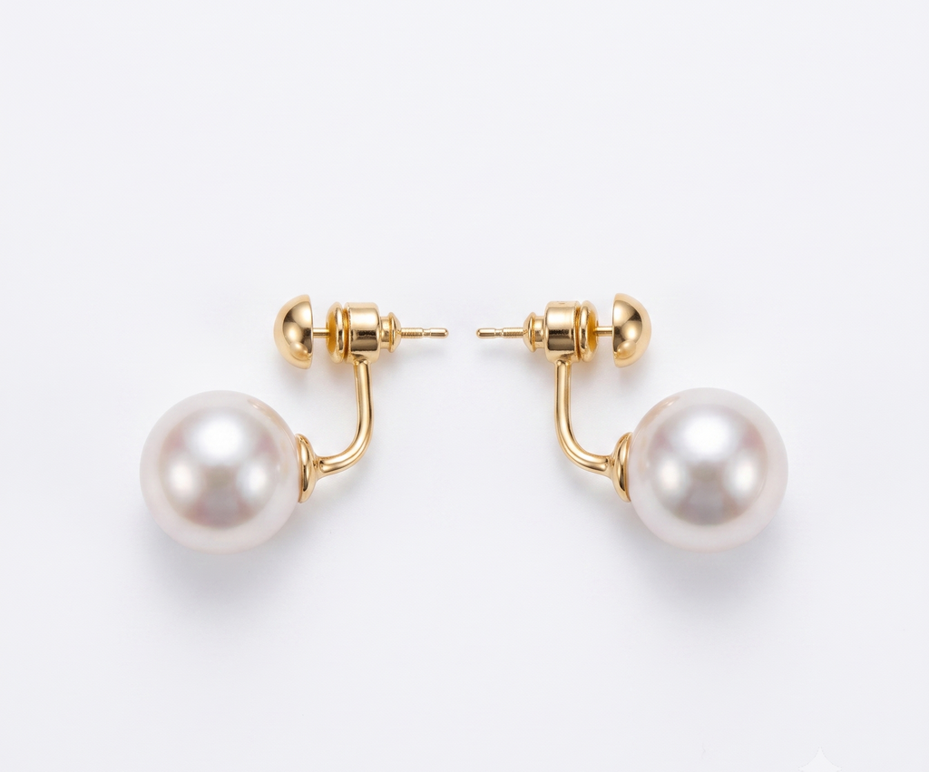 Gold ball and pearl jacket earrings flat lay