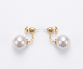 Gold ball and pearl jacket earrings flat lay