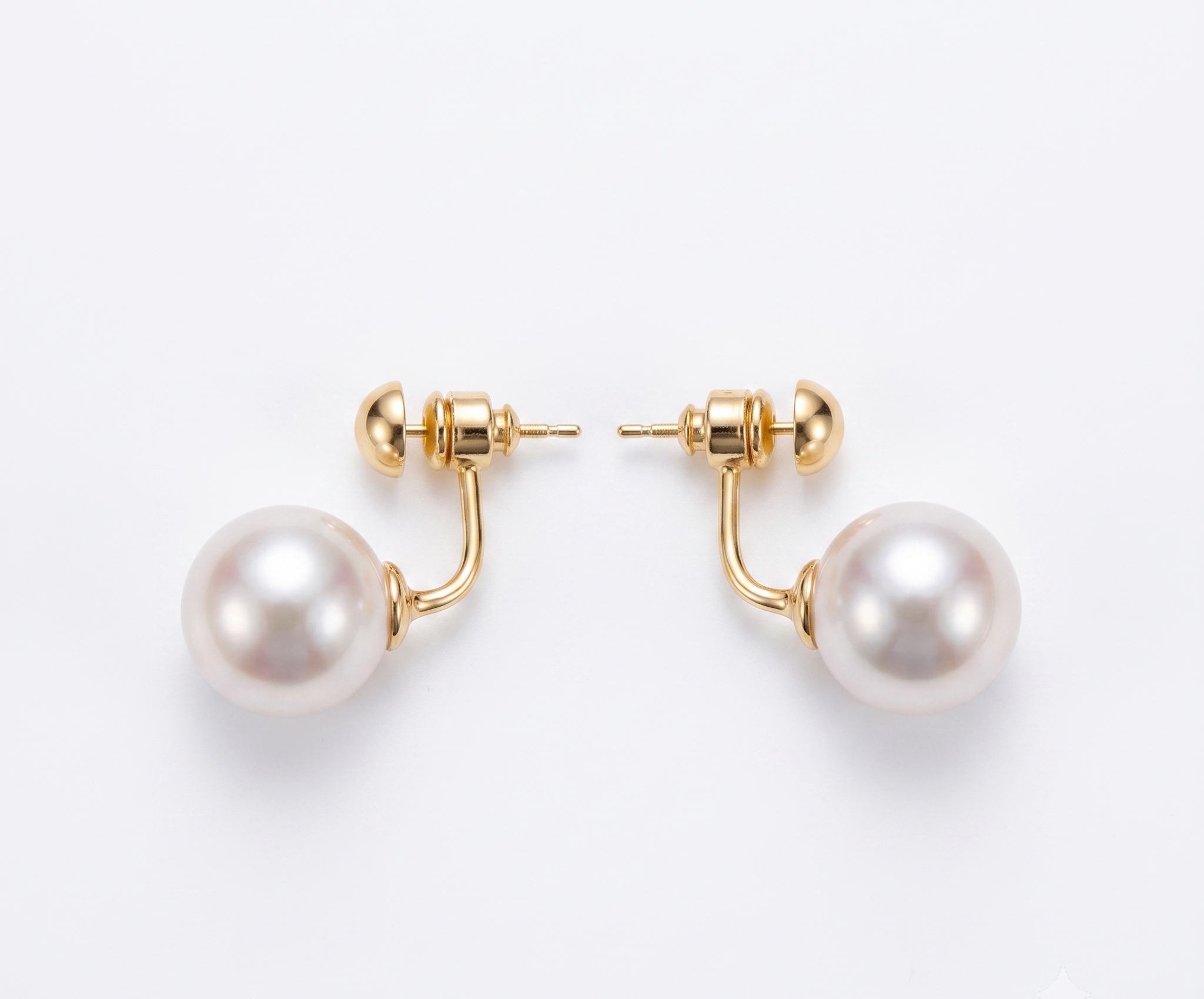 Gold ball and pearl jacket earrings flat lay