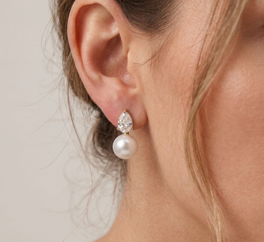 Pear crystal and pearl drop earrings worn on model