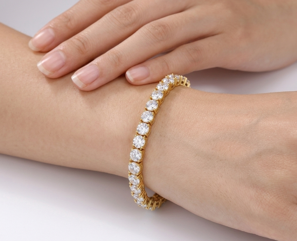 Gold statement tennis bracelet with large crystals worn on wrist