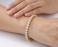 Gold statement tennis bracelet with large crystals worn on wrist
