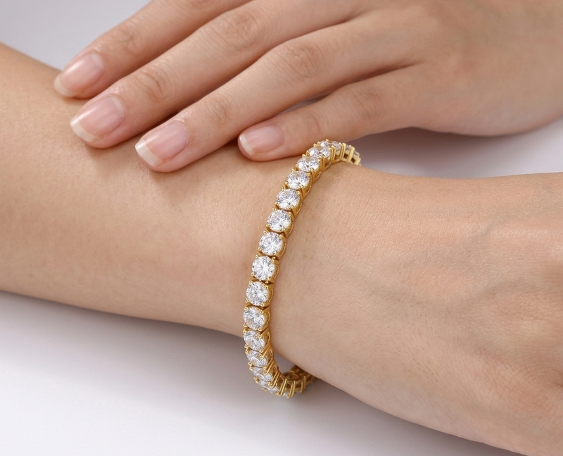 Gold statement tennis bracelet with large crystals worn on wrist