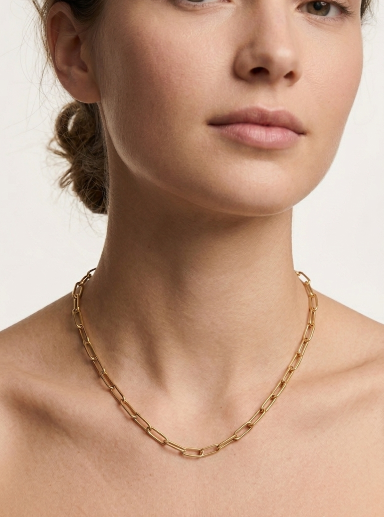Model wearing gold paperclip chain necklace