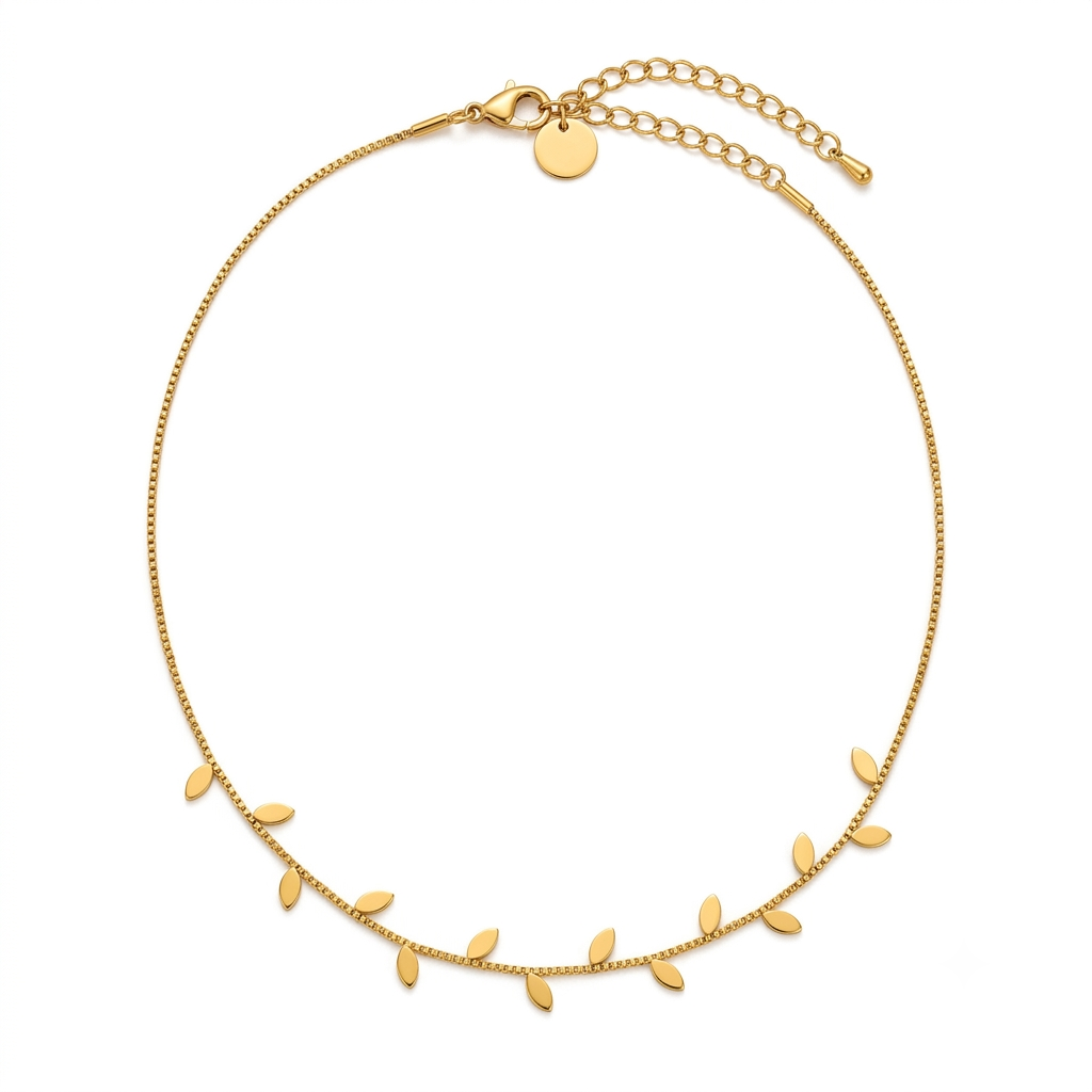 Gold leaf charm necklace flat lay on white background