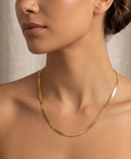 Model wearing gold herringbone chain necklace